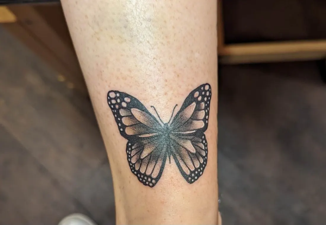 Black and grey butterfly tattoo with dotwork shading